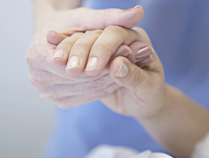 nurse holding patient's hand